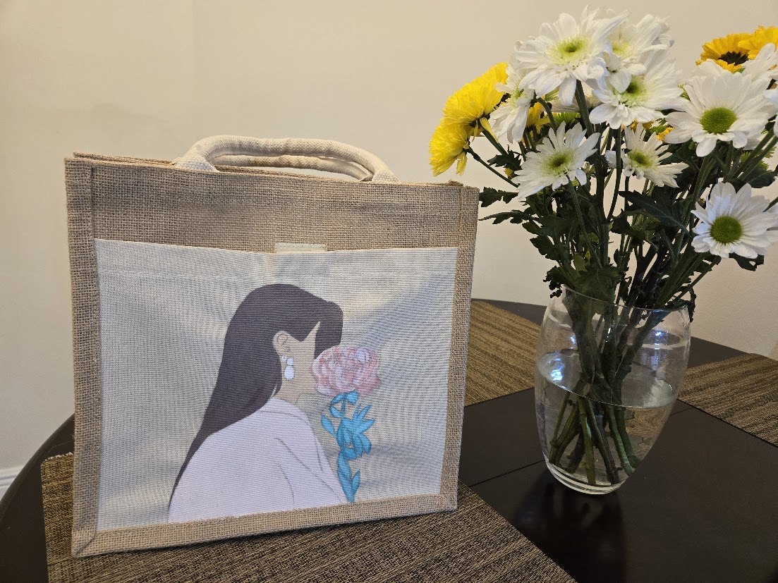 Jute bag painted with a woman holding blue flowers