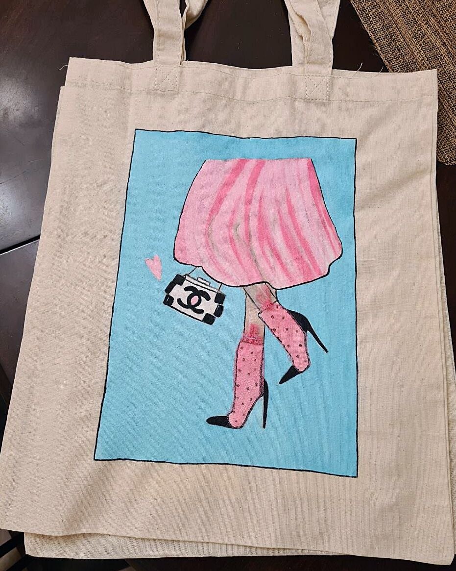 Canvas tote painted with a pink skirt and boots