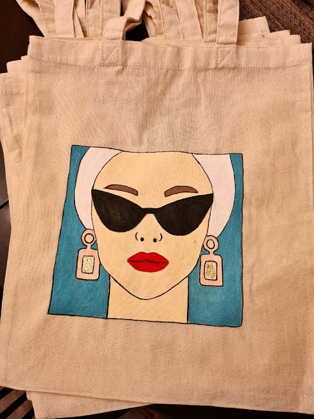 Canvas tote with a painted portrait wearing black sunglasses