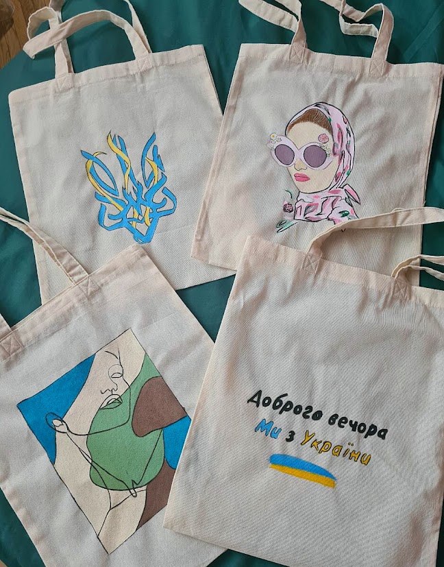 A collection of hand-painted canvas totes with different designs