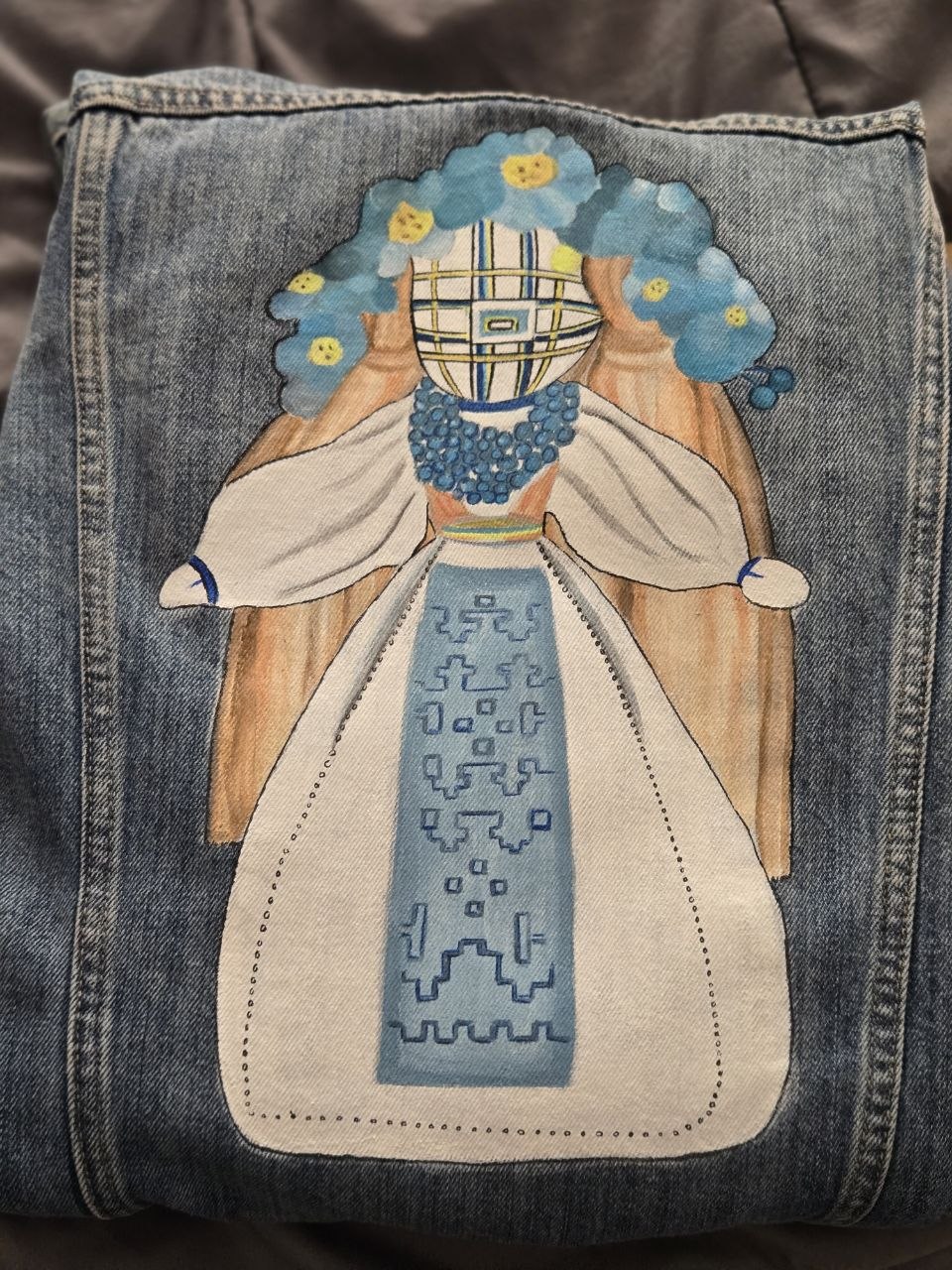 Denim with a hand-painted woman in Ukrainian-inspired dress