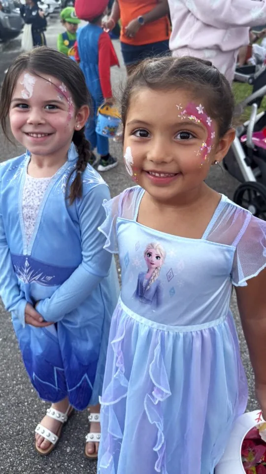 Children showing sparkle and princess face-painting designs
