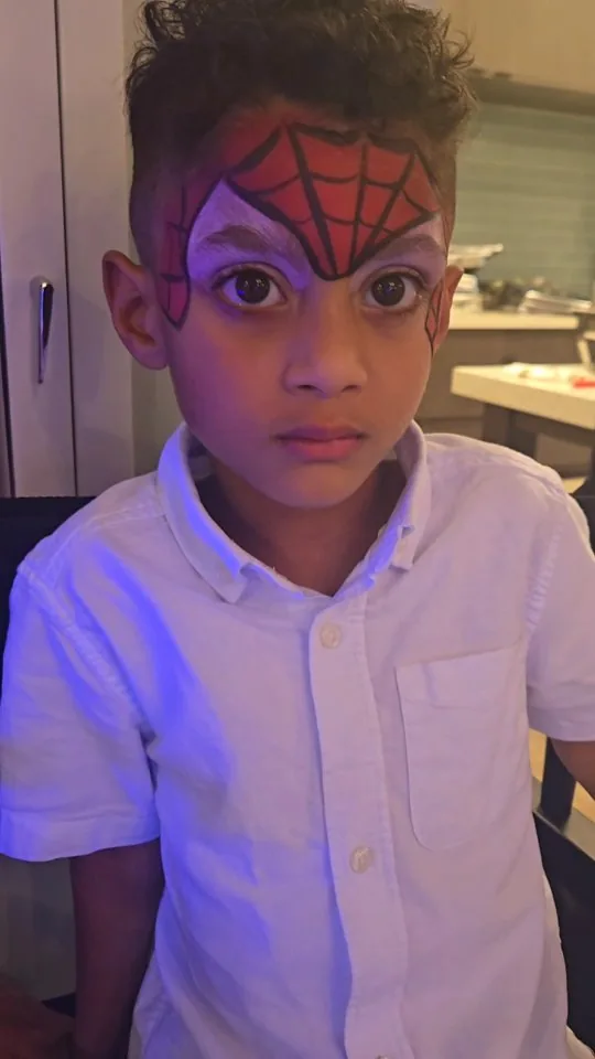 Spider-inspired face paint created by Oksana