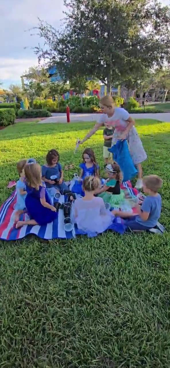 Oksana leading a group activity with children in a park