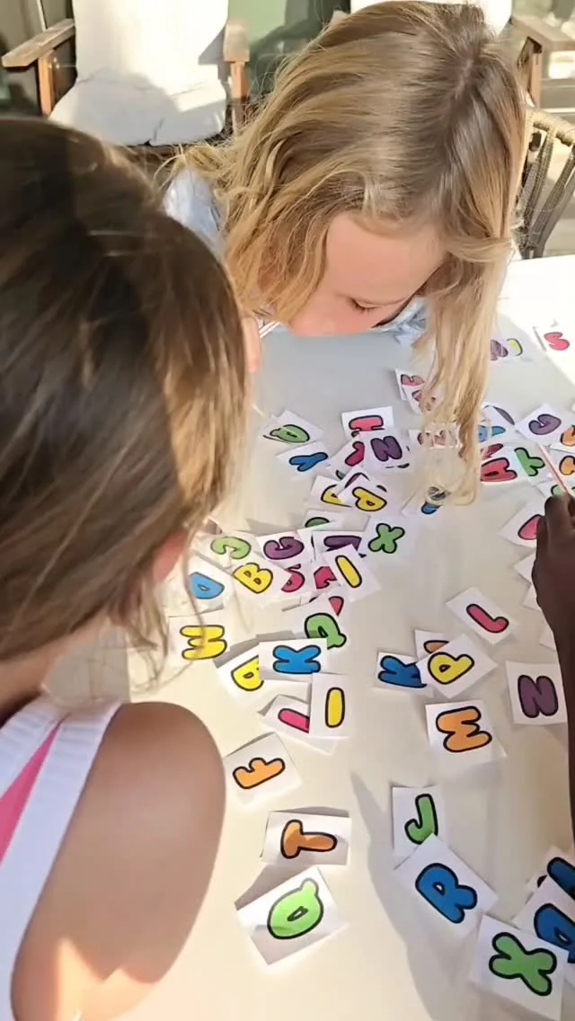 Children working together on a colorful letter activity