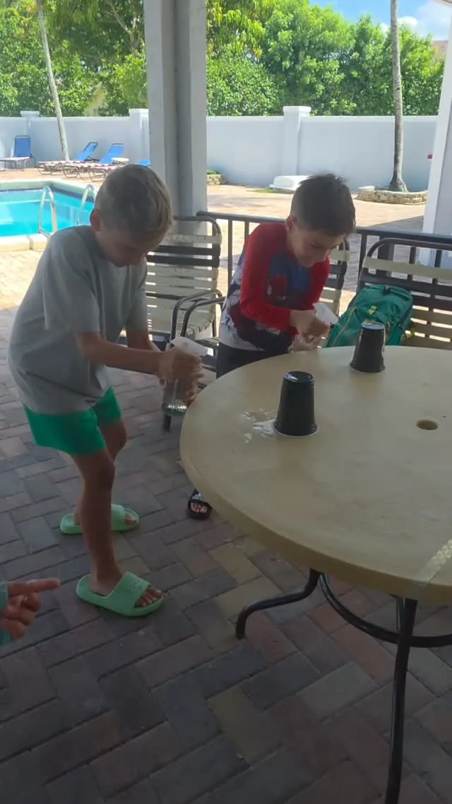 Children taking part in a party game by the pool