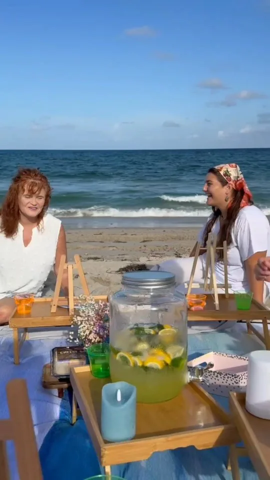 Guests enjoying an art workshop beside the ocean